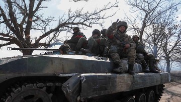 Service members of pro-Russian troops in uniforms without insignia are seen atop of an armored vehicle during Ukraine-Russia conflict outside the separatist-controlled town of Volnovakha in the Donetsk region, Ukraine March 12, 2022. REUTERS/Alexander Ermochenko