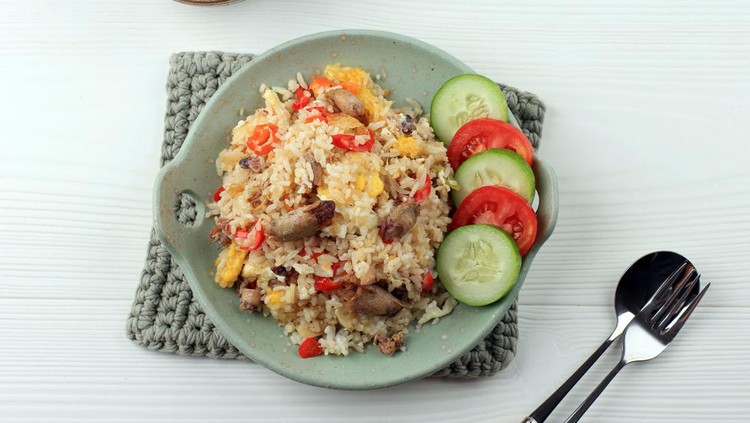 nasi goreng Nasi Goreng Cumi Asin (Fried Rice with Salted Squid), Cooked with Chilli, Spicy and Delicious. Typical Indonesian Homemade Food. Served on Green Plate, Isolated on White Background. Top View