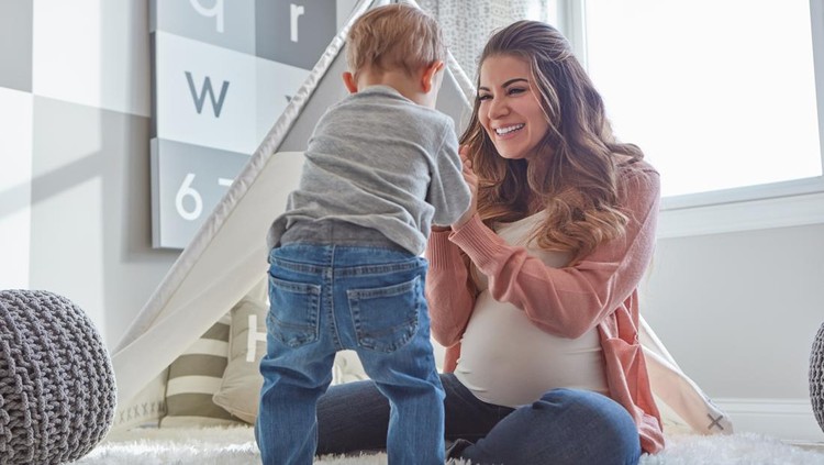 Shot of a pregnant woman bonding with her toddler son at home
