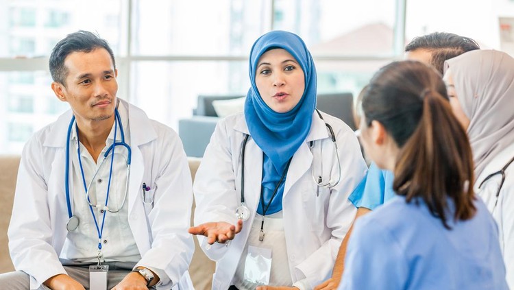 A doctor conducting a brief to the team