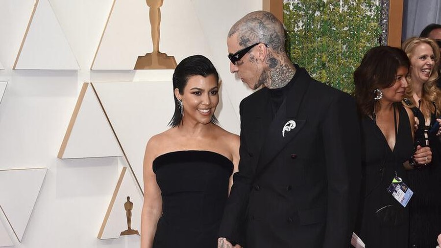 Kourtney Kardashian, left, and Travis Barker arrive at the Oscars on Sunday, March 27, 2022, at the Dolby Theatre in Los Angeles. (Photo by Jordan Strauss/Invision/AP)