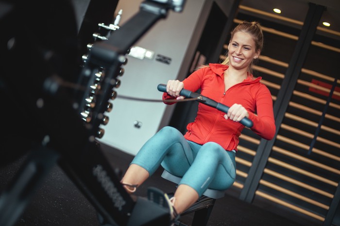 A view at a beautiful and strong woman dedicated to her gym routine. She's training hard to keep her body in shape.