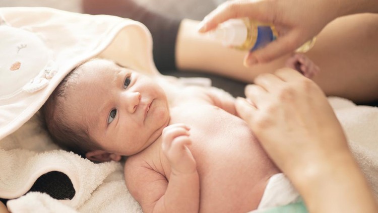 Ilustrasi Stimulasi Bayi dengan Minyak Telon Mother makes massage with baby oil