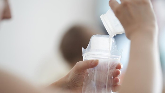 Mother pouring milk