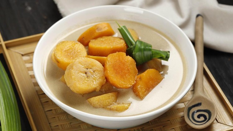 kolak pisang ubi Kolak Pisang Ubi, Indonesian Popular Dessert for Takjil Ramdan Breaking the Fast, Sweet Soup Made from Banana and Sweet Potato, on Wooden Table