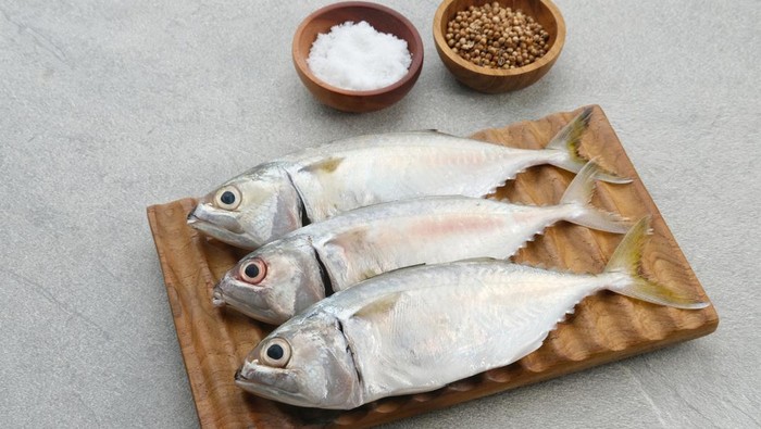 Ikan Kembung, Kembung Fish or Mackerel Fish on wooden chopping board.