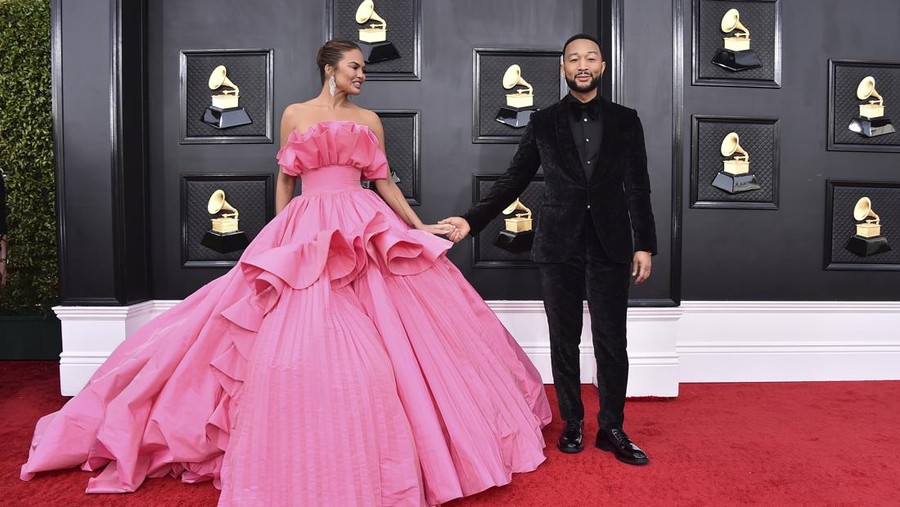 Chrissy Teigen, left, and John Legend arrive at the 64th Annual Grammy Awards at the MGM Grand Garden Arena on Sunday, April 3, 2022, in Las Vegas. (Photo by Jordan Strauss/Invision/AP)