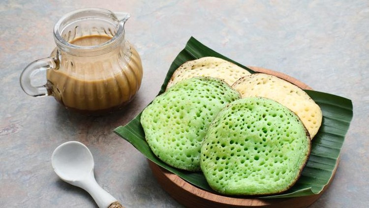 Serabi or Surabi,  Indonesian pancake made of flour, rice flour and coconut milk. Served with palm sugar sauce. Sweet and savory.
