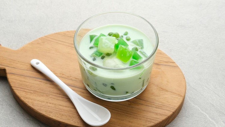 Buko Pandan, a dessert from Philippines, made from jelly, young coconut, evaporated milk, sweetened condensed milk, and ice. Served on glass. Selective focus.