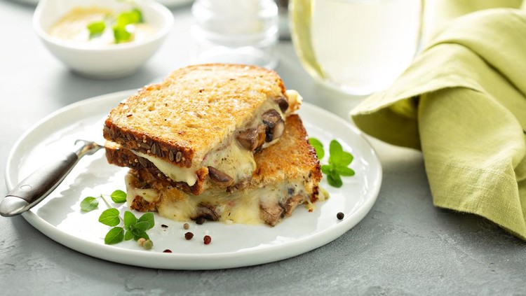 Mushroom grilled cheese sandwich on multigrain bread with thyme