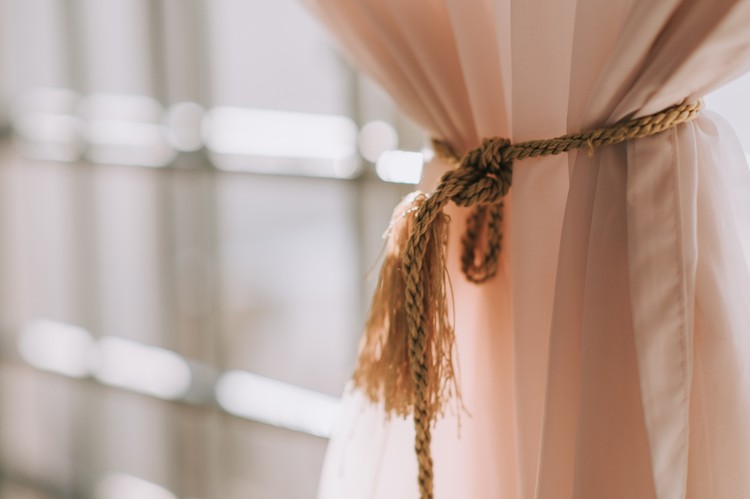 ilustrasi gorden rumah minimalis a curtain tied up with sunlight from outside window frame