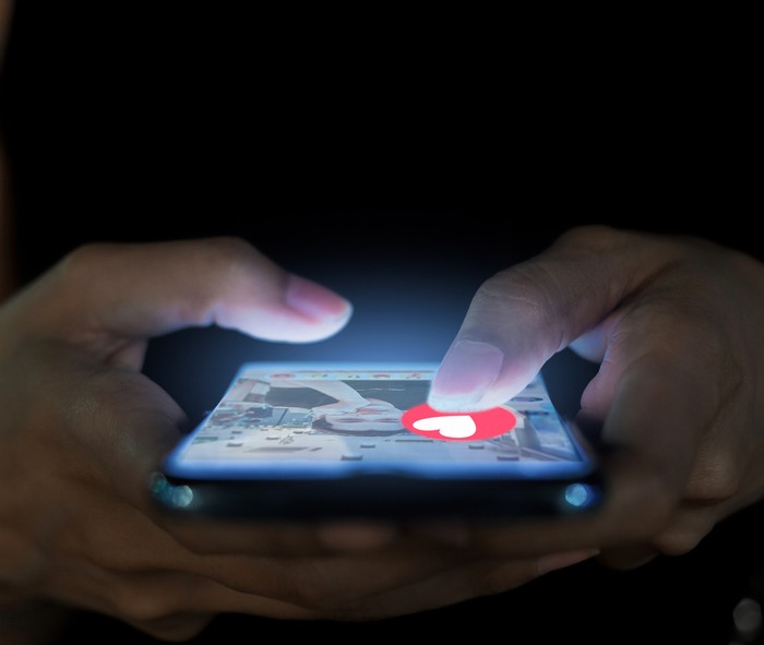 A woman using a phone for a dating app