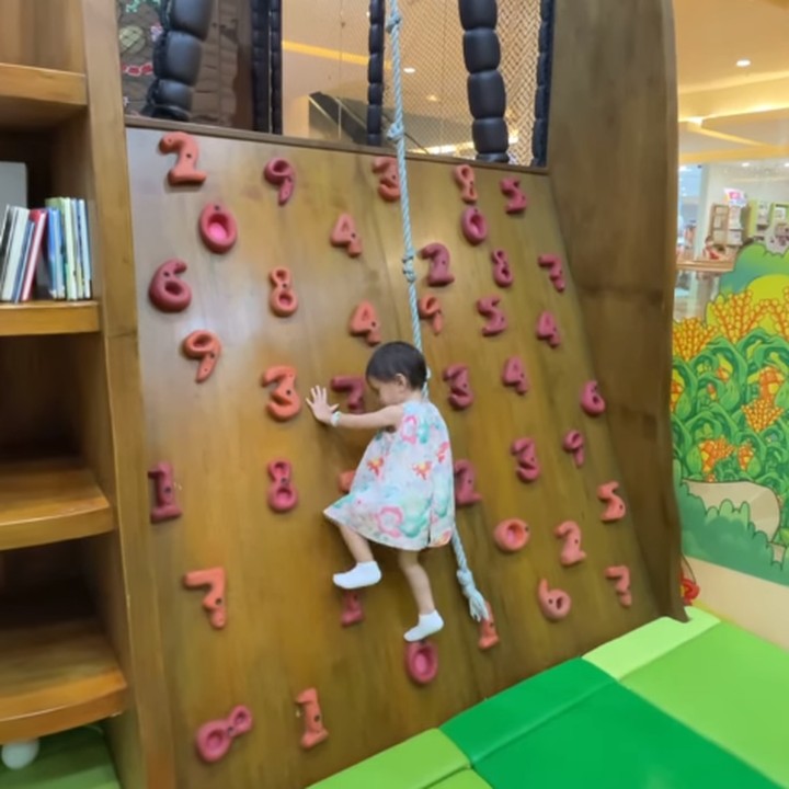 <p>Tak hanya itu, Claire juga tumbuh menjadi anak pemberani nih. Ia sudah bisa melakukan <em>wall climbing</em> untuk anak-anak di usia 2 tahun lho. (Foto: Instagram @shandyaulia/ @missclaireherbowo)</p>
