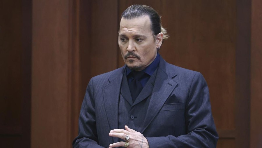 Actor Johnny Depp stands in the courtroom at the Fairfax County Circuit Court in Fairfax, Va., Thursday, April 21, 2022. Actor Johnny Depp sued his ex-wife Amber Heard for libel in Fairfax County Circuit Court after she wrote an op-ed piece in The Washington Post in 2018 referring to herself as a 