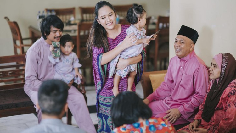 Hari raya malay muslim family in traditional clothing bonding family reunion on Hari Raya Aidilfitri / Eid-Ul-Fitr celebration in living room