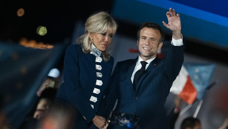 French President Emmanuel Macron and French first lady Brigitte Macron celebrate with supporters in Paris, France, Sunday, April 24, 2022. Polling agencies projected that French President Emmanuel Macron comfortably won reelection Sunday in the presidential runoff, offering French voters and the European Union the reassurance of leadership stability in the bloc's only nuclear-armed power as the continent grapples with Russia's invasion of Ukraine.