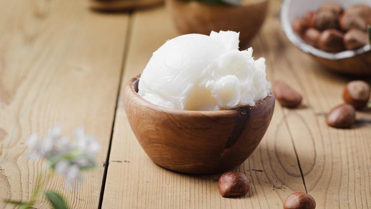 Ilustrasi Shea Butter Shea butter in wooden bowl with nuts on old rustic table. Free text space.