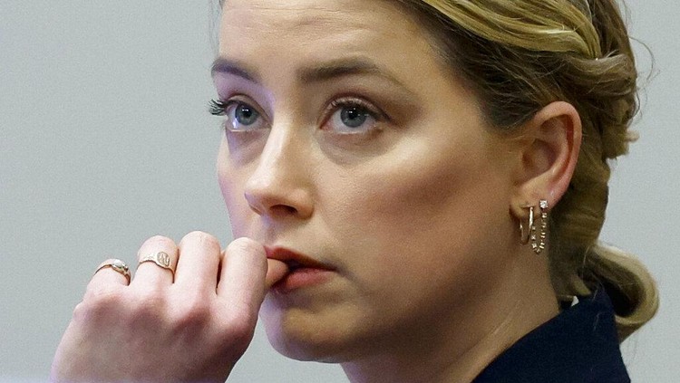 Actor Johnny Depp watches a pre-recorded deposition testimony of Christian Carino at the Fairfax County Circuit Court in Fairfax, Va., Wednesday, April 27, 2022. Depp sued his ex-wife actress Amber Heard for libel in Fairfax County Circuit Court after she wrote an op-ed piece in The Washington Post in 2018 referring to herself as a 