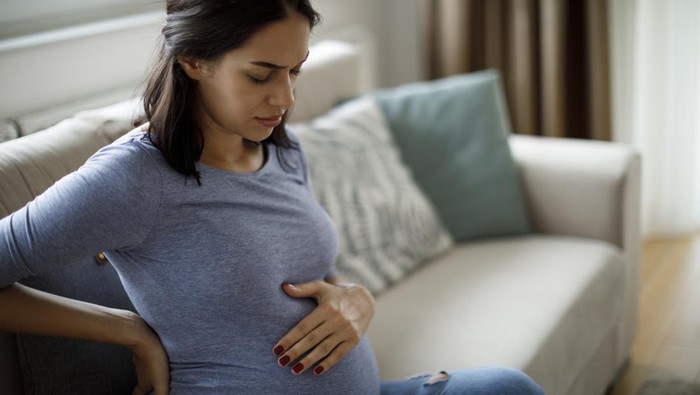 Young pregnant woman suffering from backache