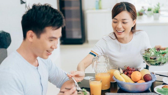 Happy young couple having fun during lunch in restaurant