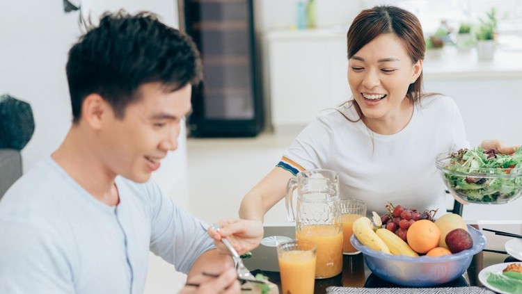 Happy young couple having fun during lunch in restaurant