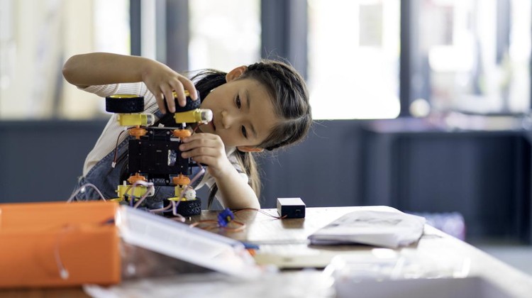Young girl working on a robot design. Okayama, Japan