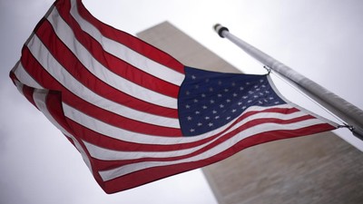 WASHINGTON, DC - MAY 12: Flags at the base of the Washington Monument fly at half staff as the United States nears the 1 millionth death attributed to COVID May 12, 2022 in Washington, DC. U.S. President ordered flags to fly at half-mast through next Monday and said the nation must stay resolved to fight the virus that has “forever changed” the country. (Photo by Win McNamee/Getty Images)