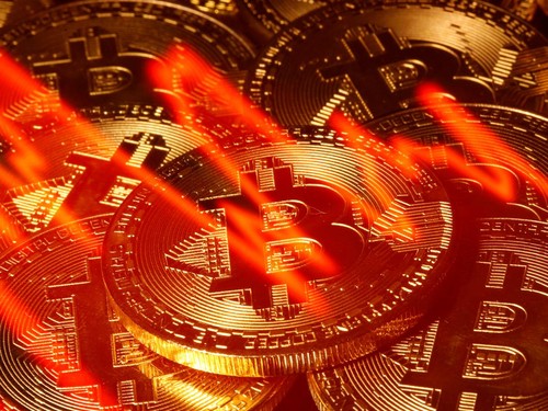 FILE PHOTO: A stock graph is seen with a representation of bitcoin in this picture illustration taken taken March 13, 2020. REUTERS/Dado Ruvic/File Photo