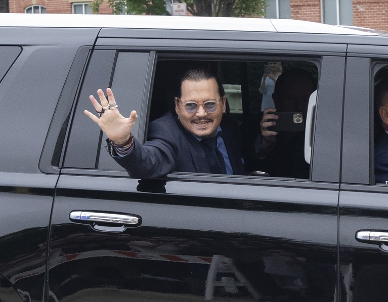 FAIRFAX, VIRGINIA - MAY 27: Actor Johnny Depp (R) takes a break during his trial at a Fairfax County Courthouse on May 27, 2022 in Fairfax, Virginia. Closing arguments in the Depp v. Heard defamation trial, brought by Johnny Depp against his ex-wife Amber Heard, begins today. (Photo by Kevin Dietsch/Getty Images)