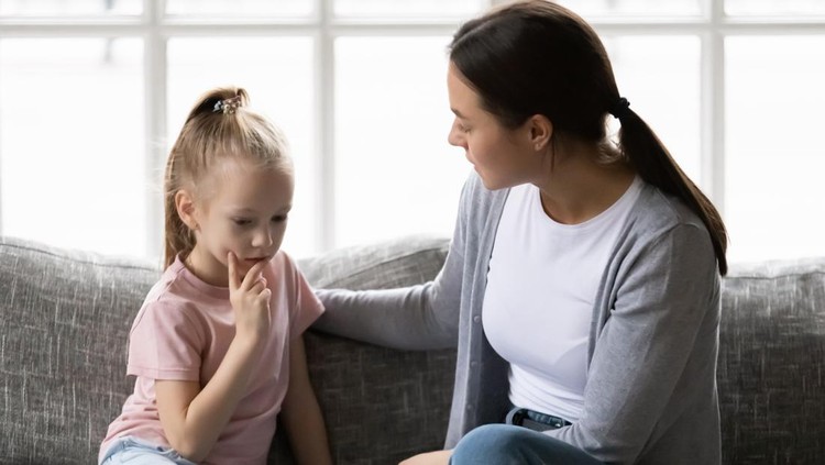 Serious mother talking to sad upset preschooler daughter kid at home. Mum consoling quiet girl, giving love, comfort, support, touching shoulder of child at home. Psychology, therapy,  empathy concept