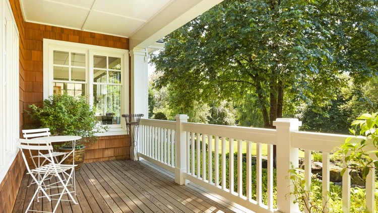 Beautiful front porch with table and chairs, on a lovely summer day