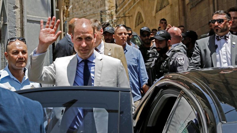Britain's Prince William waves as he walks in a street of Jerusalem's Old City after he visited the Church of the Holy Sepulchre on June 28, 2018. - The Duke of Cambridge is the first member of the royal family to make an official visit to the Jewish state and the Palestinian territories. (Photo by AHMAD GHARABLI / AFP)        (Photo credit should read AHMAD GHARABLI/AFP via Getty Images)