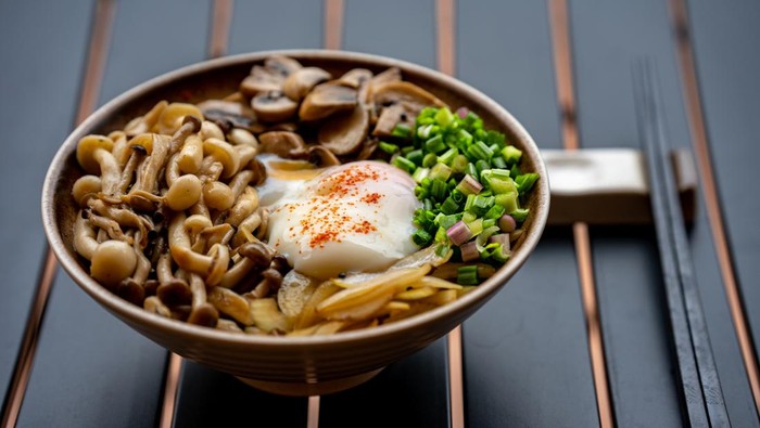 Healthy Vegetarian Don. Japanese rice served with fried onions, button mushrooms, champignon mushrooms, spring onions, clamshell mushrooms with onsen egg.
