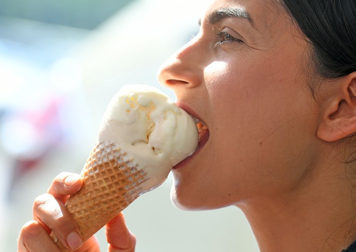 29 May 2018, Germany, Langenhagen:: A young woman enjoys a waffle ice cream at an ice cream café in the inner city during the sunny summer weather, which records temperatures of about 30 degrees. Photo: Holger Hollemann/dpa (Photo by Holger Hollemann/picture alliance via Getty Images)