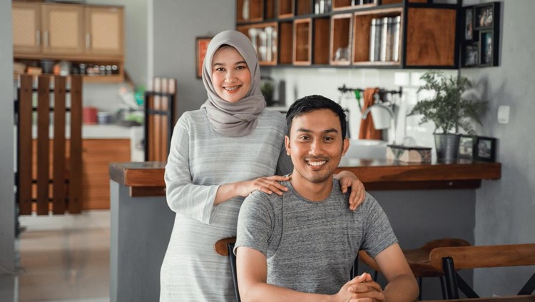 portrait of muslim couple sitting in dining room together
