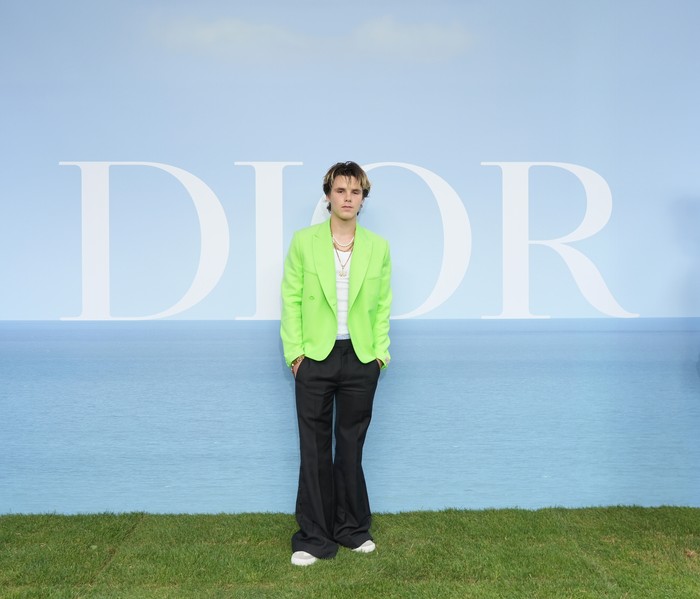 Cruz Beckham terlihat modis dengan padanan blazer warna hijau neon, kaus, dan flare pants rancangan Dior Men. Foto: Getty Images For Christian Dior/Francois Durand