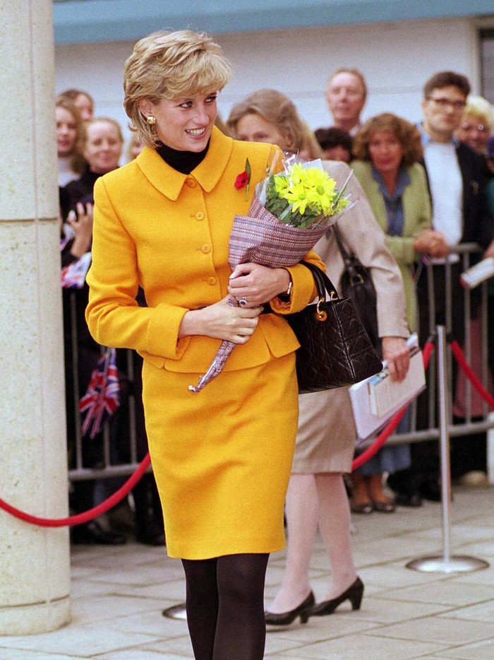 LIVERPOOL, UNITED KINGDOM - NOVEMBER 07:  Princess Diana Visiting Liverpool. Diana Is Wearing A Bright Orange Suit Designed By Fashion Designer Versace And She Is Carrying A Handbag Designed By Fashion Designer Dior.  (Photo by Tim Graham Photo Library via Getty Images)