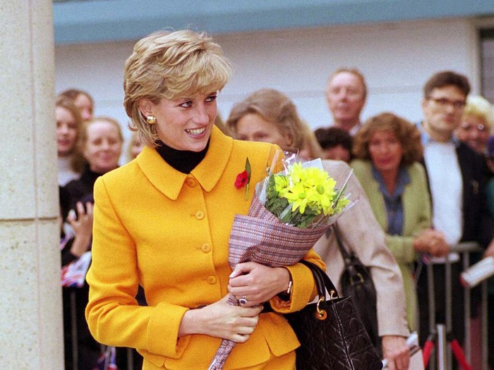 LIVERPOOL, UNITED KINGDOM - NOVEMBER 07:  Princess Diana Visiting Liverpool. Diana Is Wearing A Bright Orange Suit Designed By Fashion Designer Versace And She Is Carrying A Handbag Designed By Fashion Designer Dior.  (Photo by Tim Graham Photo Library via Getty Images)