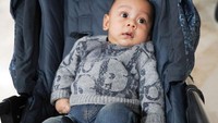 <p>Ini potretnya saat bersandar di atas <em>stroller</em>. Baby L tampil keren mengenakan <em>sweater</em> abu-abu dan celana jeans. (Foto: Instagram @rizkybillar)</p>