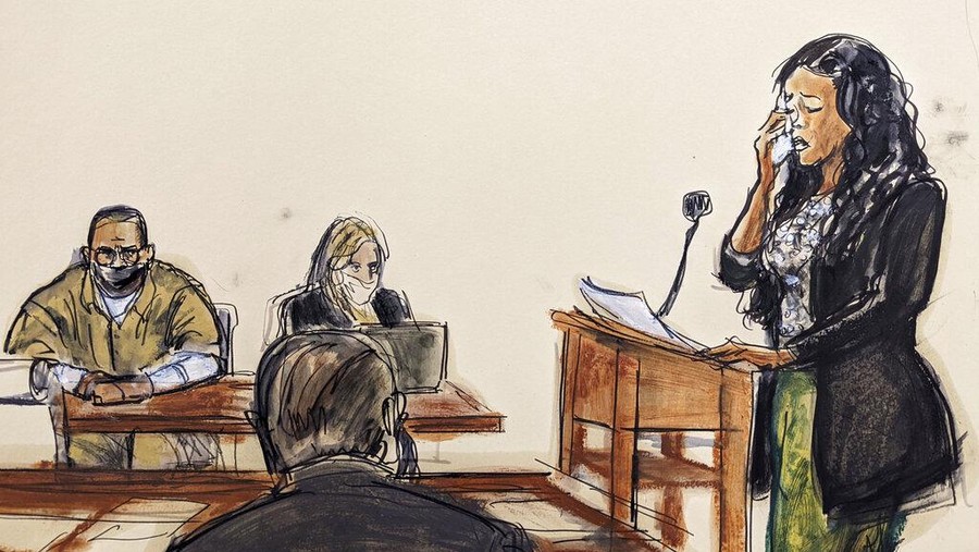 Korban Pelecehan Sekual R. Kelly In this courtroom sketch, Kitti Jones, right, speaks during R. Kelly's sentencing in federal court, Wednesday, June 29, 2022, in New York. Kelly and his attorney Ashley Cohen are seated, background left. The former R&B superstar was convicted of racketeering and other crimes. (AP Photo/Elizabeth Williams)