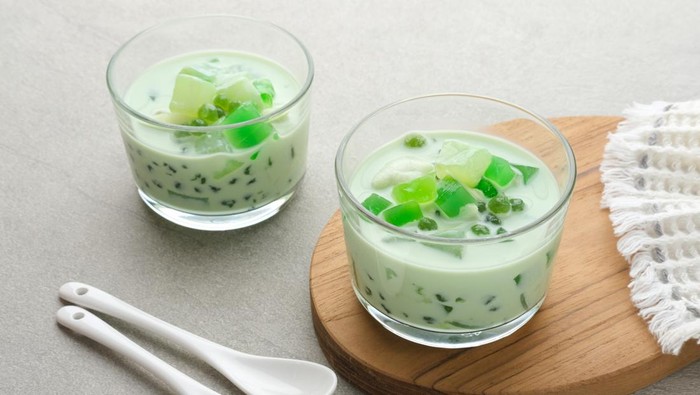 Buko Pandan, a dessert from Philippines, made from jelly, young coconut, evaporated milk, sweetened condensed milk, and ice. Served on glass. Selective focus.