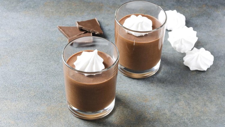 Tasty mousse with chocolate.Two glass cup full of chocolate mouse on grey rustic table.Empty space for your text