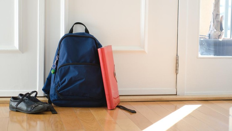 Tas sekolah Back to school or ready for school concept with school bag and shoes by front door