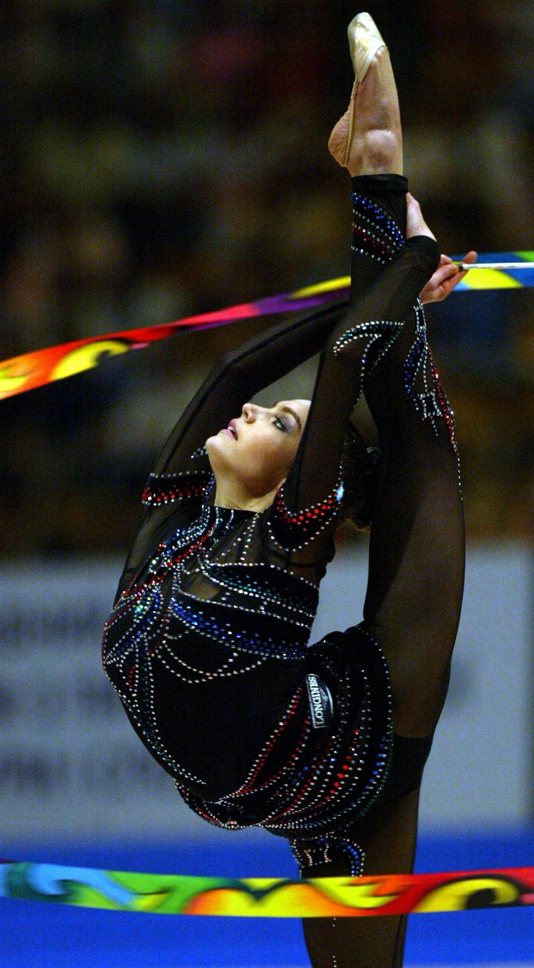 Alina Kabaeva Russian Alina Kabaeva performs with a ribbon during the individual competition of the European Championship in Rhythmic Gymnastics in Kiev, 06 June 2004. Kabaeva became Champion of Europe in the individual competition. Gymnasts from 28 countries took part in the championship in the Ukrainian capital. AFP PHOTO/ Sergei SUPINSKY/ ss (Photo by Sergei SUPINSKY / AFP) (Photo by SERGEI SUPINSKY/AFP via Getty Images)