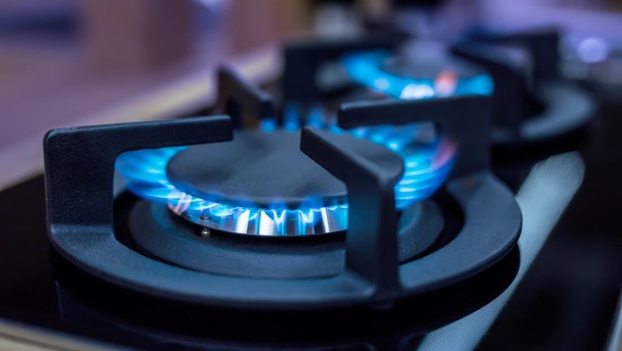 Closeup man's hand operating valve of LPG cylinder for cooking