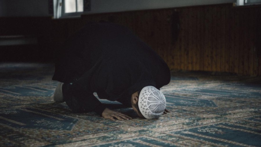 Shot of a Muslim young man worshiping in a mosque.
