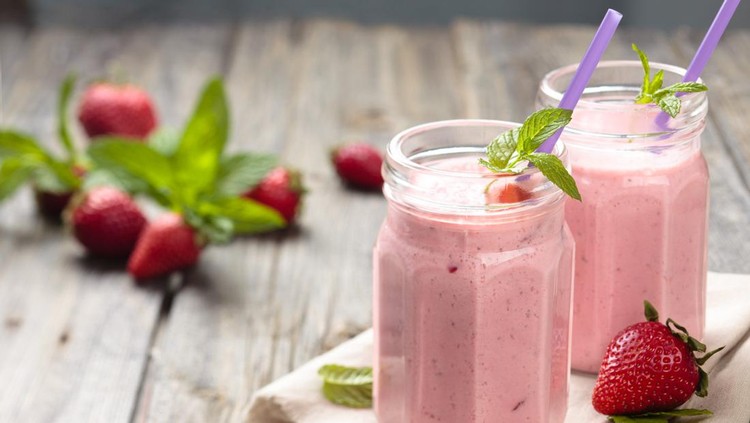 Fruit smoothie with mint leaves on wooden rustik table