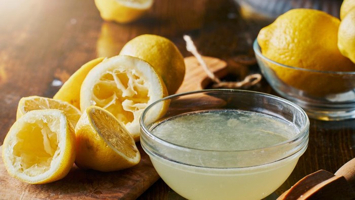bowl full of freshly squeezed lemon juice shot with selective focus