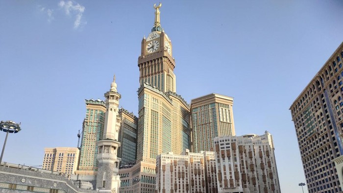 photo of Abraj Al Bait (Royal Clock Tower Makkah) and Umrah pilgrims at the Grand Mosque. makkah, saudi arabia 14 august 2019