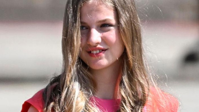 (From L) Spain's Queen Letizia and Spanish Crown Princess of Asturias Leonor wave as they leave on Obradoiro Square after attending the 